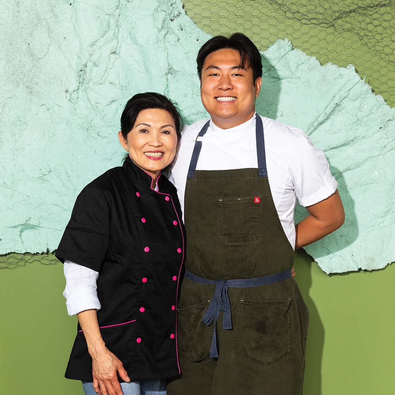 Chef Eric Pham standing and smiling together with his mother, Khue.
