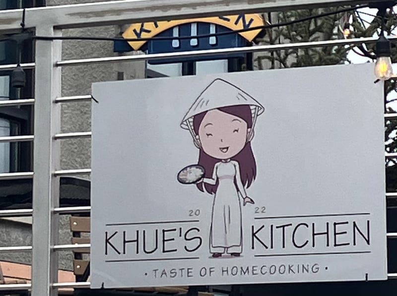 Outdoor sign on the patio of Khue's Kitchen restaurant.